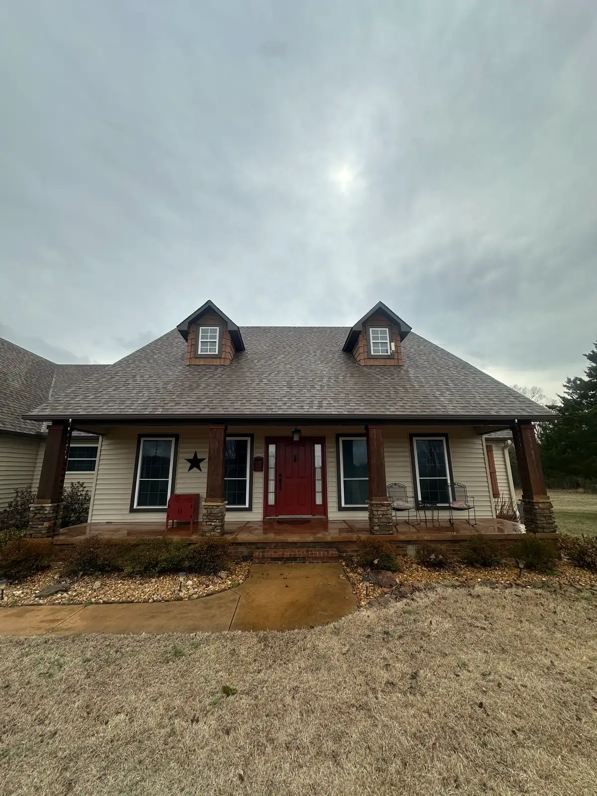 The same Heber Springs home after roof soft washing — clean shingles with the black streaking removed